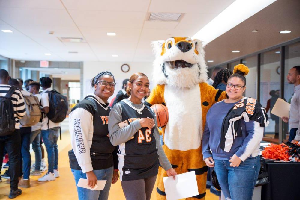 students posing with mascot