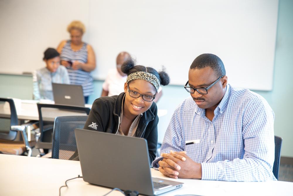 students together at laptop